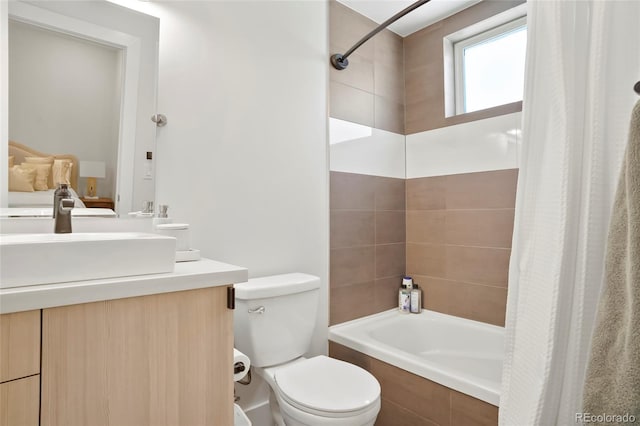 full bathroom with vanity, shower / tub combo, and toilet