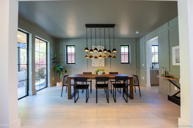 dining area featuring light hardwood / wood-style floors, sink, and plenty of natural light