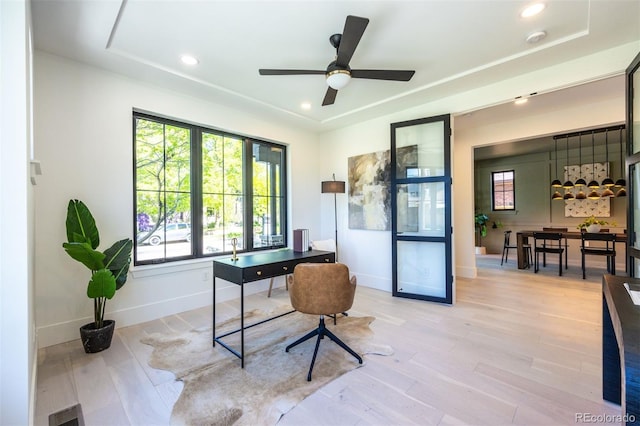 office space with light hardwood / wood-style floors and ceiling fan