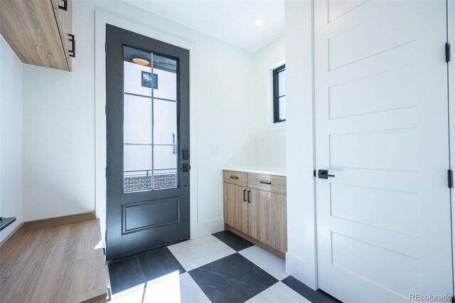 doorway to outside with light tile floors