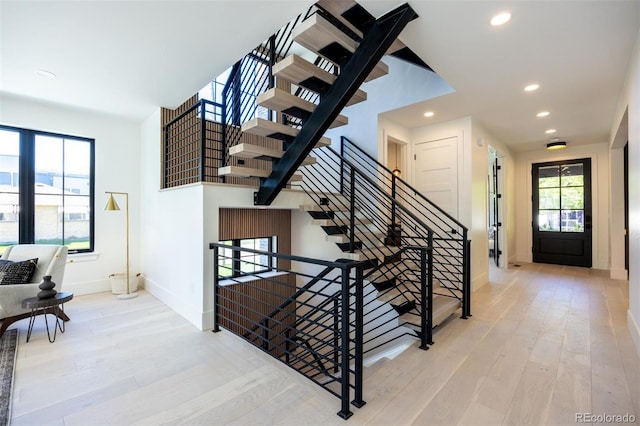 stairs with light hardwood / wood-style flooring