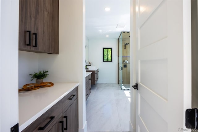 bathroom with tile floors, walk in shower, and vanity