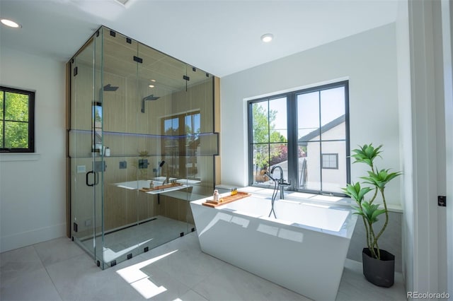 bathroom featuring tile flooring and separate shower and tub