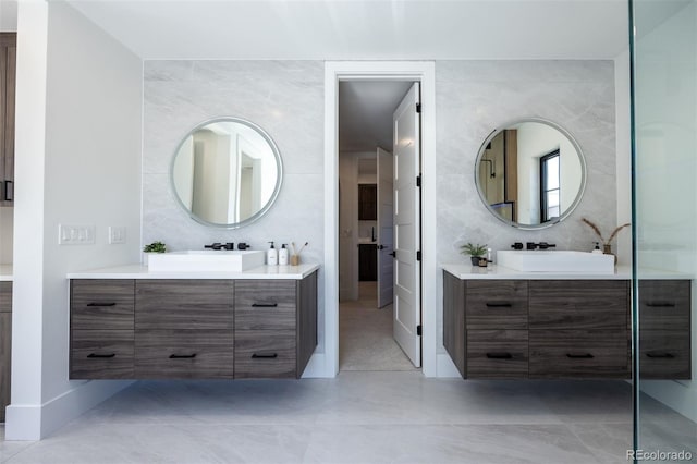 bathroom featuring vanity, tasteful backsplash, and tile walls