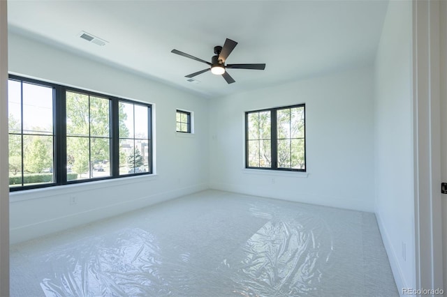 empty room with plenty of natural light and ceiling fan