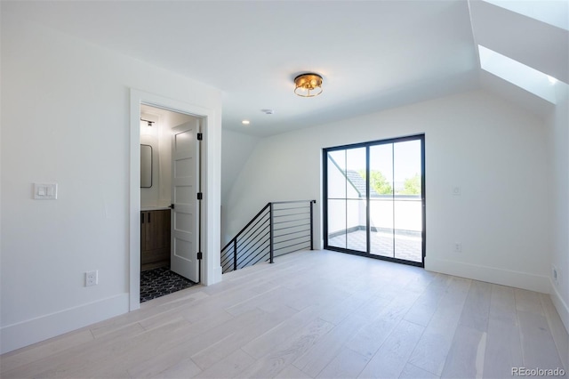 additional living space with lofted ceiling and light wood-type flooring