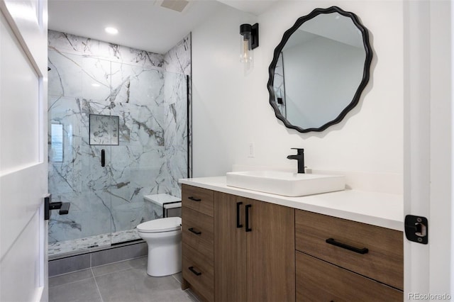 bathroom featuring vanity, toilet, tile floors, and a shower with door