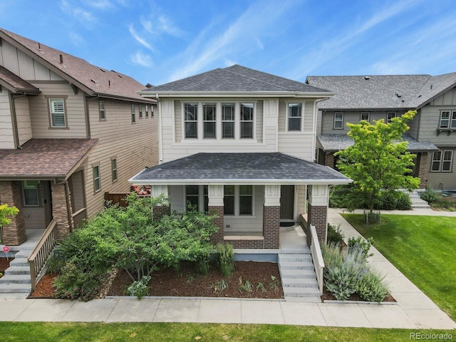 5841 Alton St, Denver, CO 80238 - view of front of house with stairway, a porch, brick siding, and roof with shingles