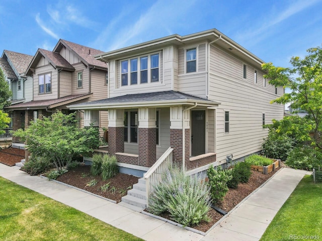 5841 Alton St, Denver, CO 80238 - view of front of house with a porch and brick siding