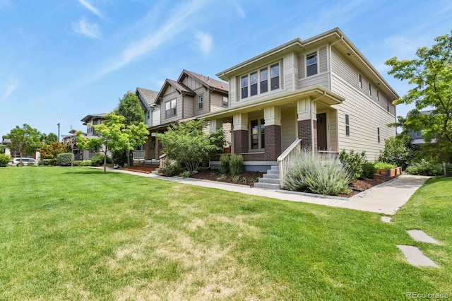 5841 Alton St, Denver, CO 80238 - view of front of property featuring brick siding, covered porch, and a front lawn