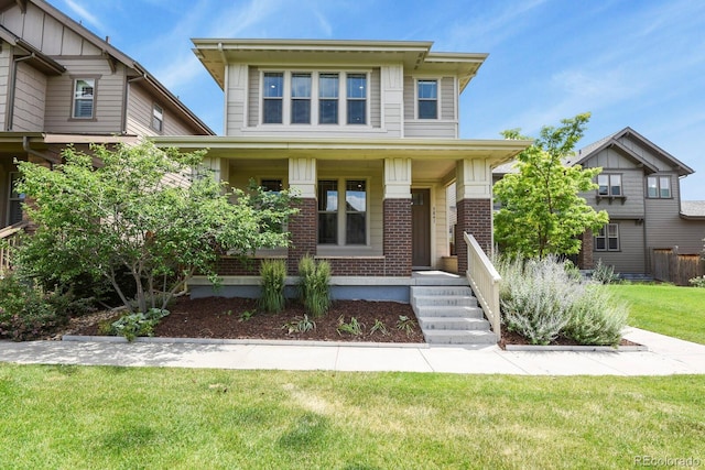 5841 Alton St, Denver, CO 80238 - view of front of property with covered porch, brick siding, and a front yard