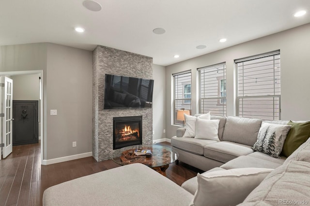 5841 Alton St, Denver, CO 80238 - living room featuring a stone fireplace, dark wood finished floors, and recessed lighting