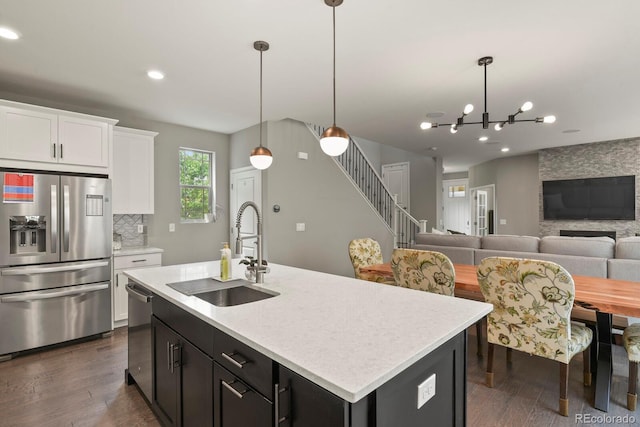 5841 Alton St, Denver, CO 80238 - kitchen with stainless steel appliances, dark wood-type flooring, light countertops, and recessed lighting