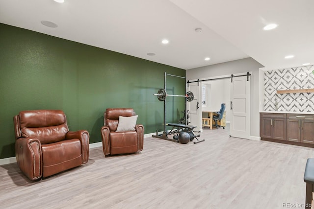 5841 Alton St, Denver, CO 80238 - sitting room with a barn door, light wood-style floors, and recessed lighting