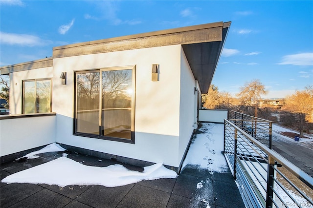 view of snowy exterior with a balcony