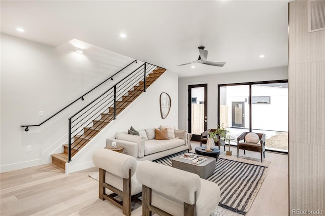 living room with ceiling fan and light hardwood / wood-style flooring