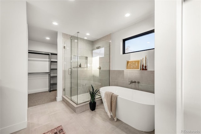 bathroom with independent shower and bath and tile patterned flooring