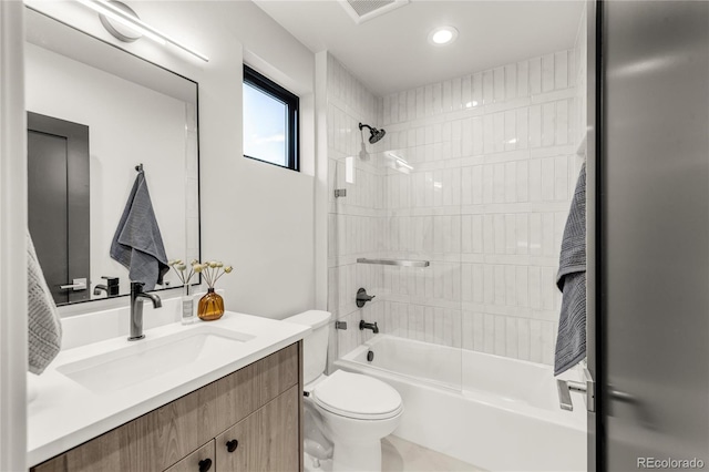 full bathroom featuring vanity, toilet, and tiled shower / bath