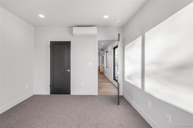 unfurnished bedroom with light colored carpet and an AC wall unit