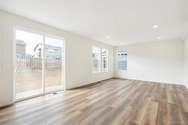 empty room with light hardwood / wood-style floors