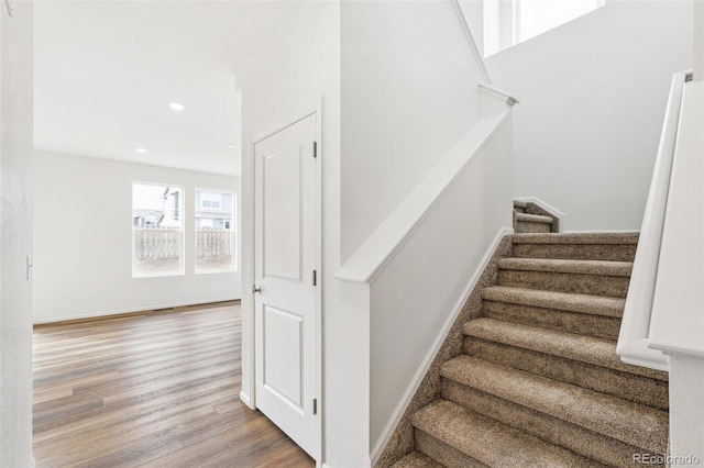 stairs with hardwood / wood-style flooring