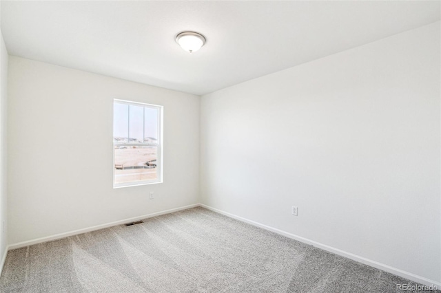 unfurnished room featuring carpet