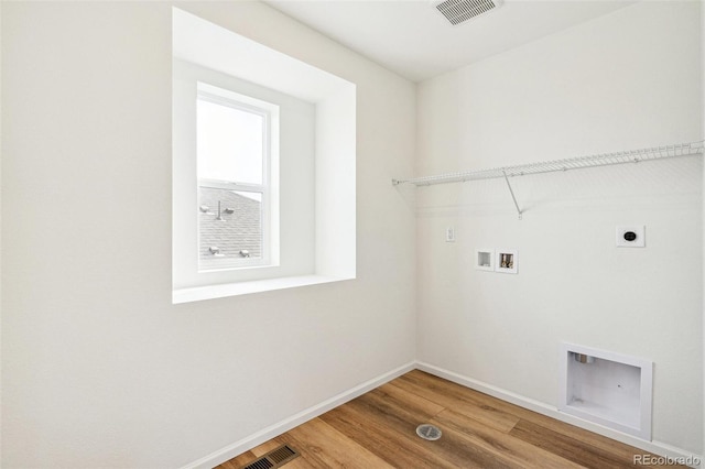 laundry area with hardwood / wood-style floors, electric dryer hookup, and washer hookup