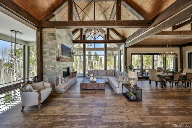living area with a chandelier, hardwood / wood-style flooring, a fireplace, wood ceiling, and beam ceiling