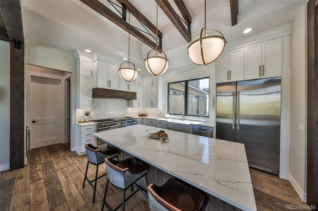 kitchen with stainless steel built in refrigerator, under cabinet range hood, dark wood-type flooring, tasteful backsplash, and recessed lighting