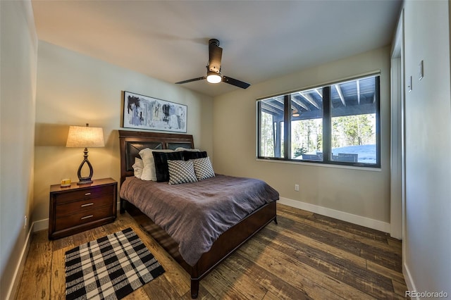 bedroom featuring dark wood-type flooring, baseboards, and a ceiling fan