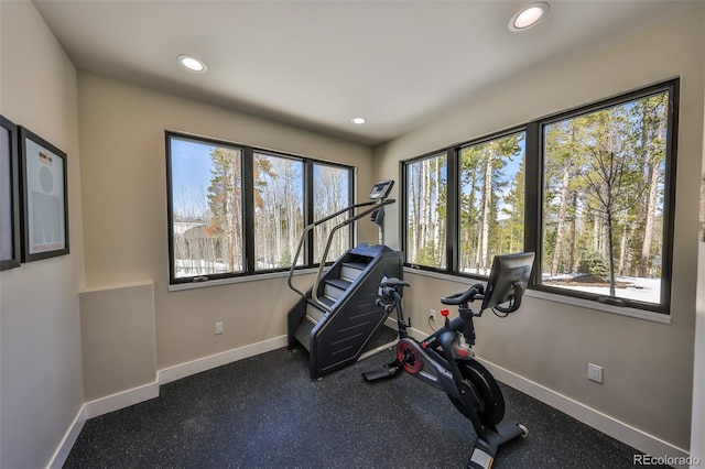 workout room featuring baseboards, plenty of natural light, and recessed lighting
