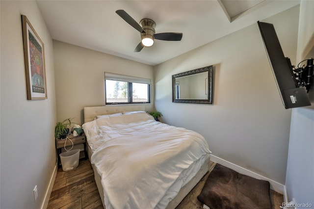 bedroom with baseboards, wood finished floors, and a ceiling fan