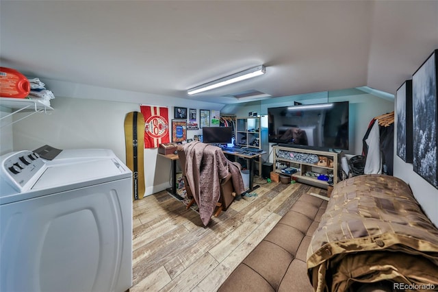 laundry area featuring washing machine and clothes dryer and wood finished floors