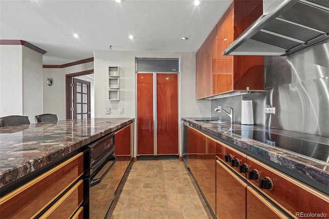 kitchen with ventilation hood, black electric stovetop, sink, ornamental molding, and paneled fridge