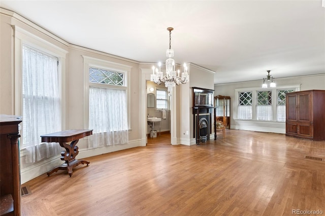 120 E Espanola St, Colorado Springs, CO 80907 - dining area with a chandelier, light wood finished floors, plenty of natural light, and crown molding