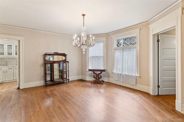 120 E Espanola St, Colorado Springs, CO 80907 - dining space with light wood-style floors, a chandelier, and crown molding
