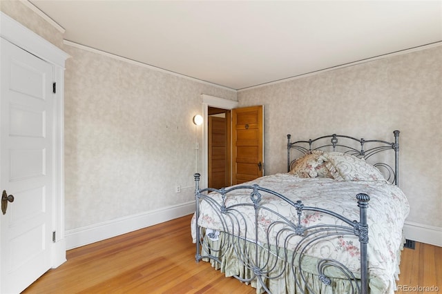 120 E Espanola St, Colorado Springs, CO 80907 - bedroom featuring wood finished floors and ornamental molding