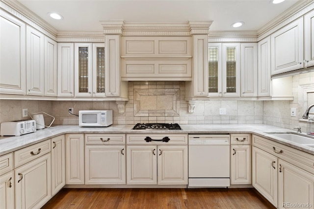 120 E Espanola St, Colorado Springs, CO 80907 - kitchen with white appliances, backsplash, glass insert cabinets, light stone counters, and crown molding