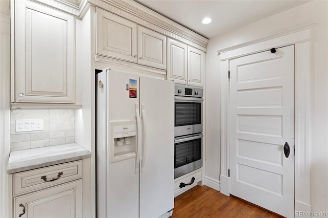 120 E Espanola St, Colorado Springs, CO 80907 - kitchen featuring white refrigerator with ice dispenser, double oven, wood finished floors, backsplash, and recessed lighting