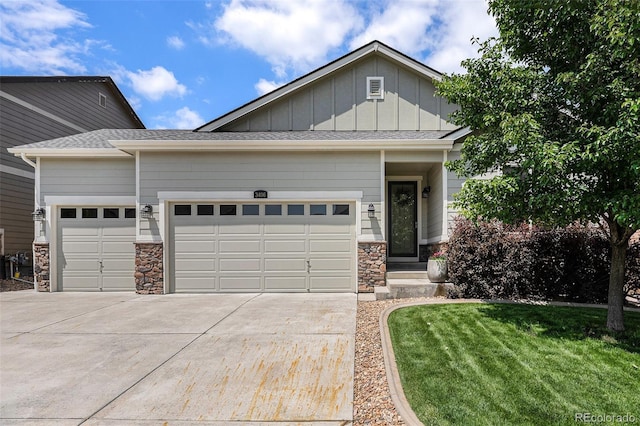 3406 Quicksilver Rd, Frederick, CO 80516 - view of front facade featuring an attached garage, concrete driveway, stone siding, board and batten siding, and a front yard