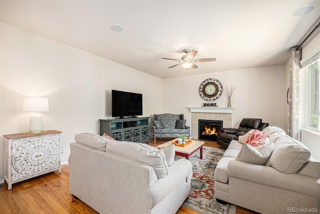 3406 Quicksilver Rd, Frederick, CO 80516 - living room with light wood-type flooring, ceiling fan, and a tiled fireplace