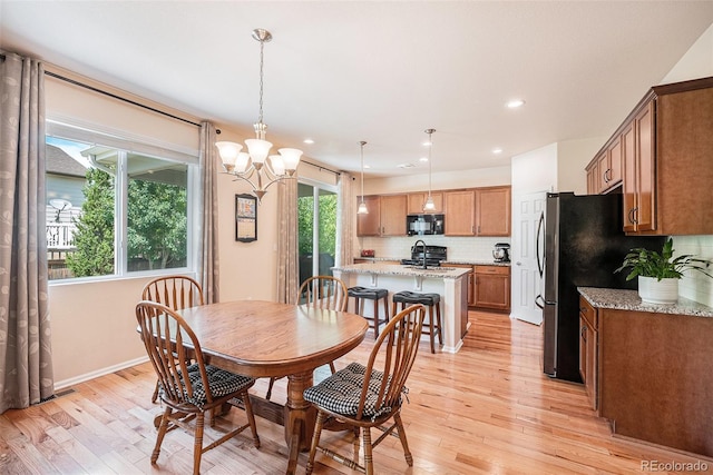 3406 Quicksilver Rd, Frederick, CO 80516 - dining room with light wood-style floors, a chandelier, and recessed lighting