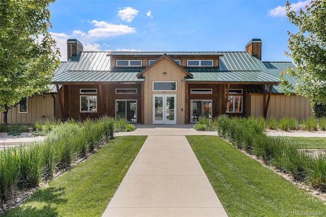 3406 Quicksilver Rd, Frederick, CO 80516 - view of front of property featuring a chimney, french doors, board and batten siding, and a standing seam roof