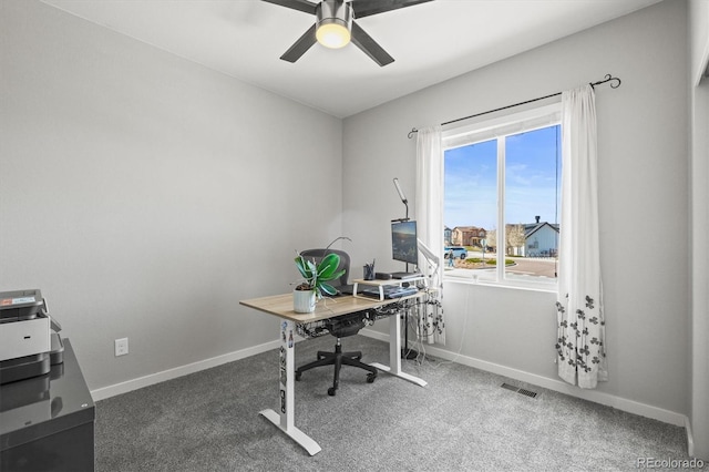 office space with carpet flooring, baseboards, a ceiling fan, and visible vents