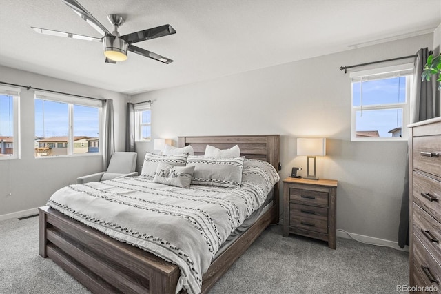 carpeted bedroom with baseboards and ceiling fan