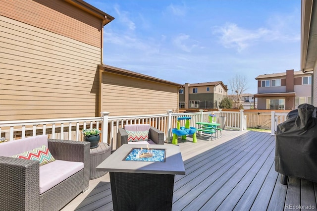 deck with an outdoor living space with a fire pit