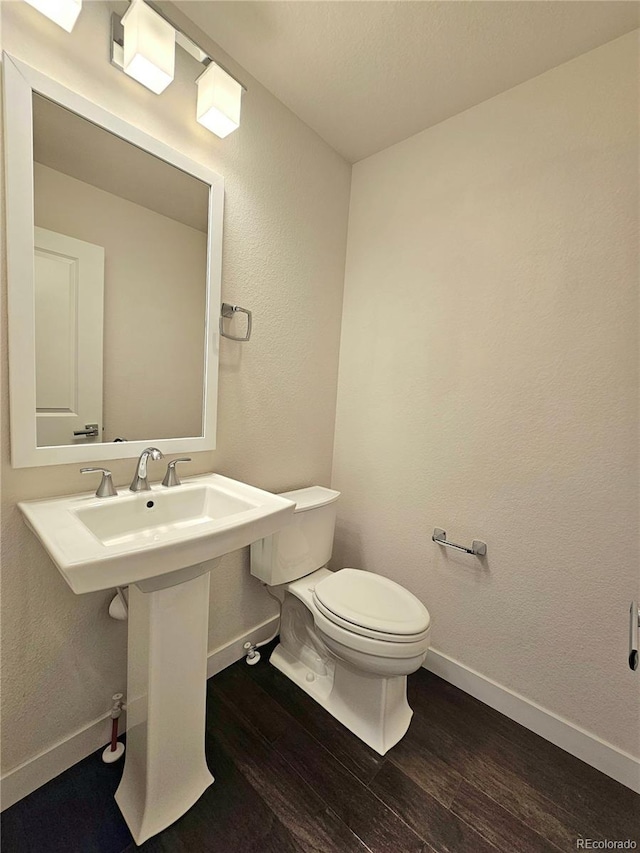 bathroom featuring sink, toilet, and hardwood / wood-style floors