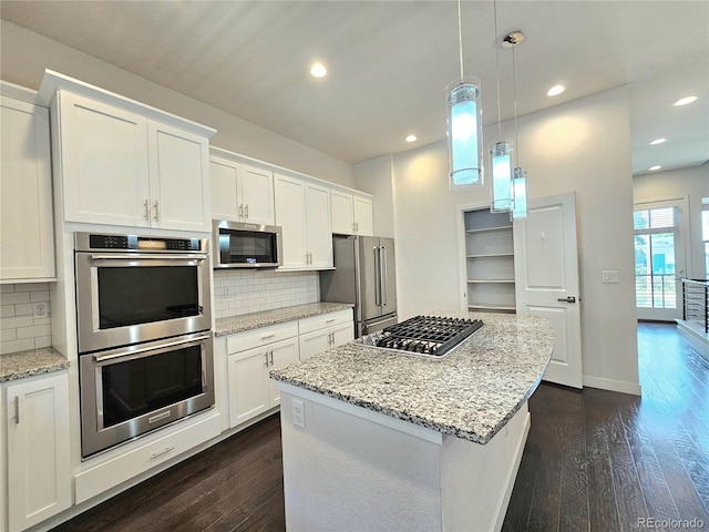 kitchen featuring decorative backsplash, dark hardwood / wood-style floors, and stainless steel appliances