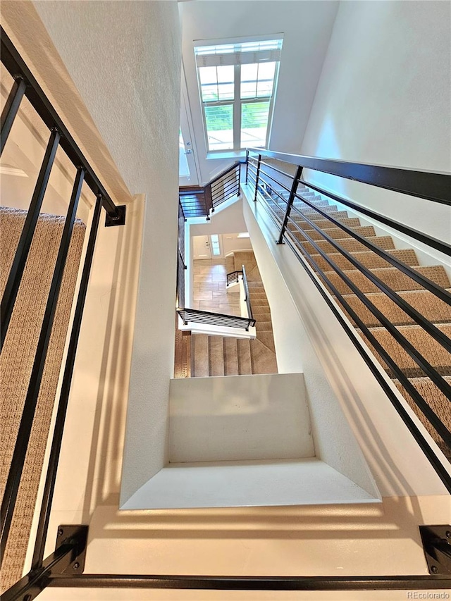 staircase featuring a high ceiling