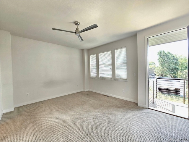 unfurnished room with ceiling fan and light carpet